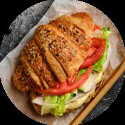 Croissant with slices of chicken and vegetables