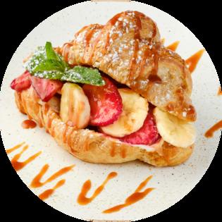 Croissant with sour cream, fresh berries, banana and caramel sauce