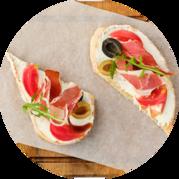 Bruschetta with prosciutto, olives and tomatoes
