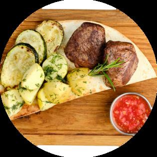 Medallions of beef with new potatoes, zucchini and homemade adjika