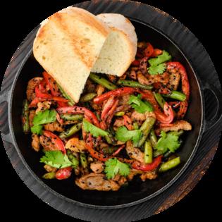 Пательня зі свининою та овочами з кисло-солодким соусом
